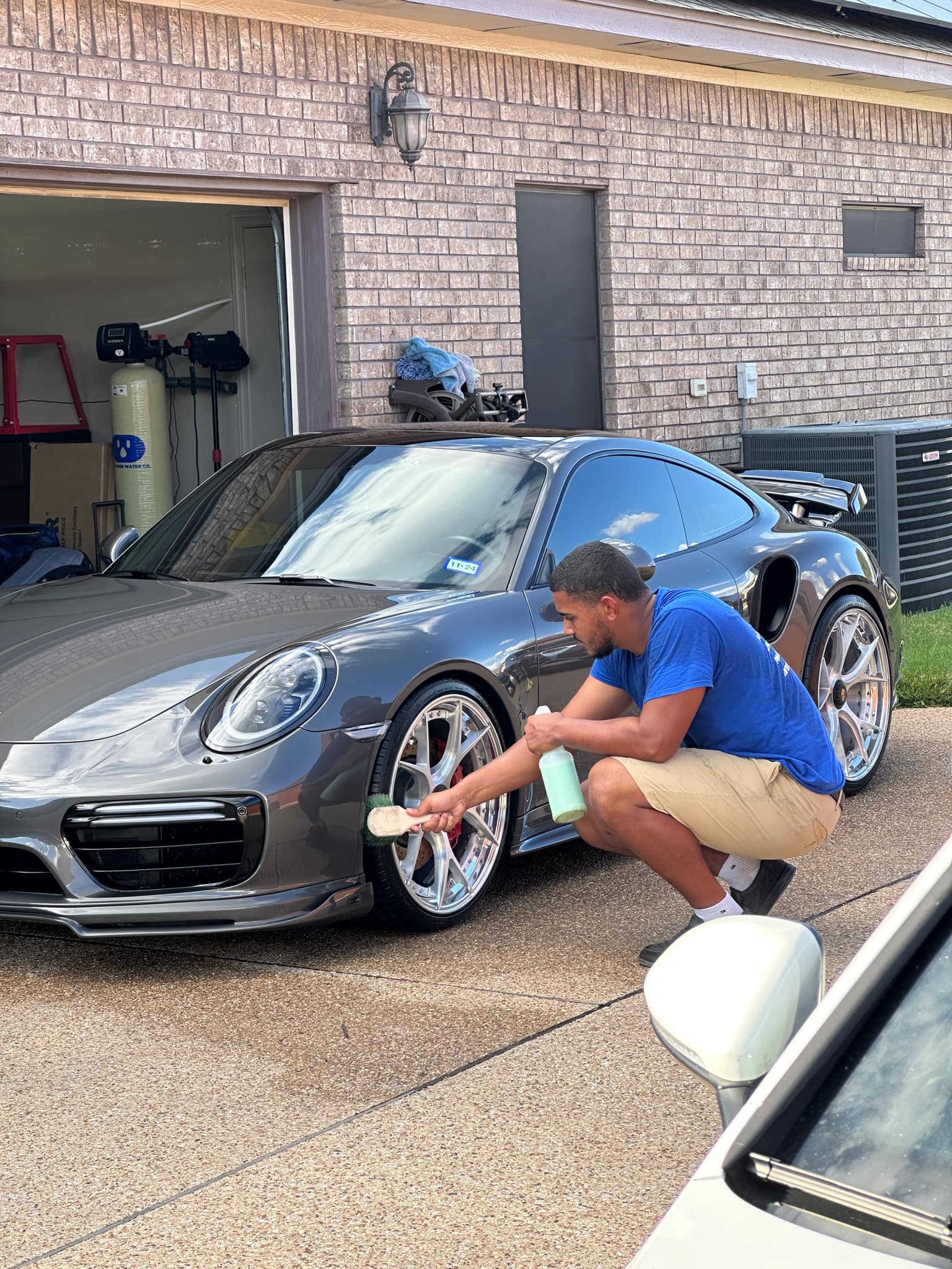 Technician at SkyRides Auto Care applying ceramic coating to a car in Killeen, TX.